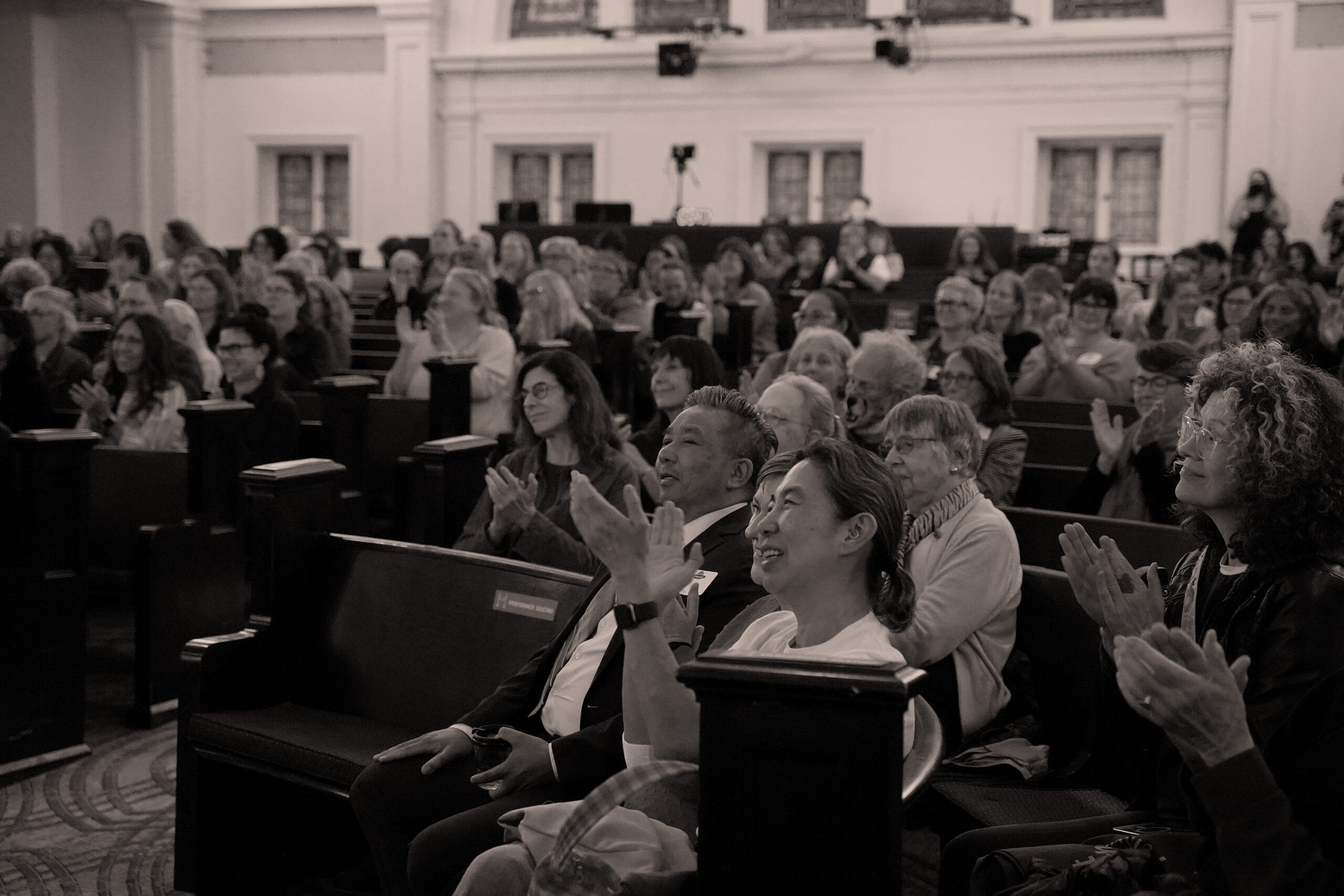 Attendees applaud at a public lecture event at Town Hall Seattle.
