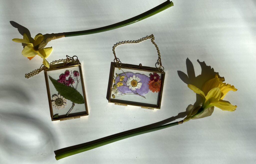flowers in a frame with yellow flowers surrounding it.