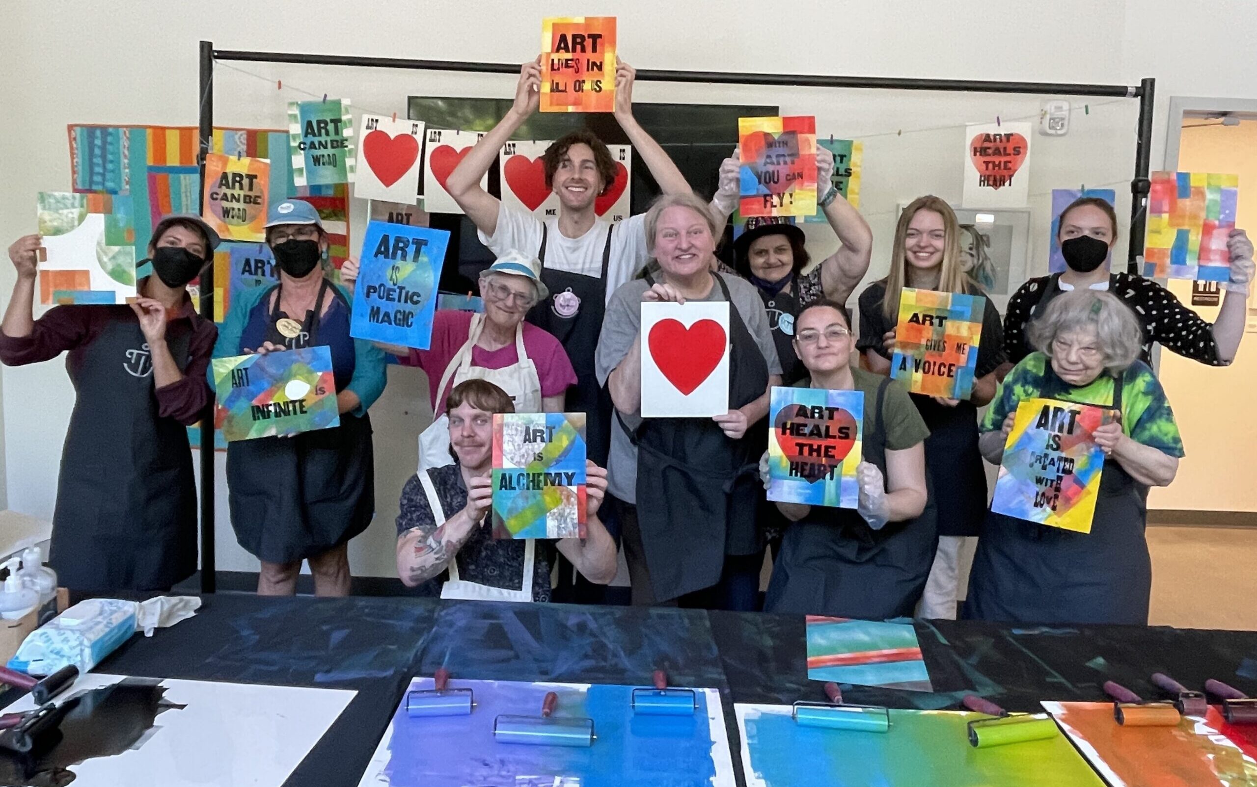 Picture of artists holding their printed artworks