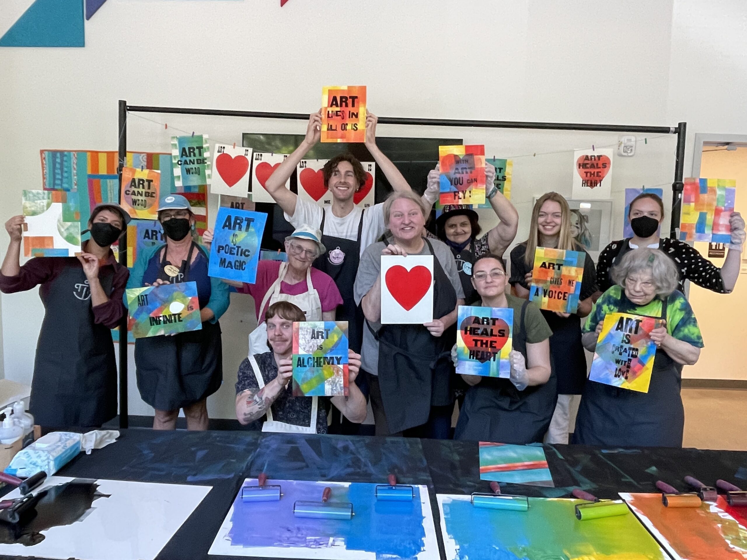Picture of artists holding their printed artworks
