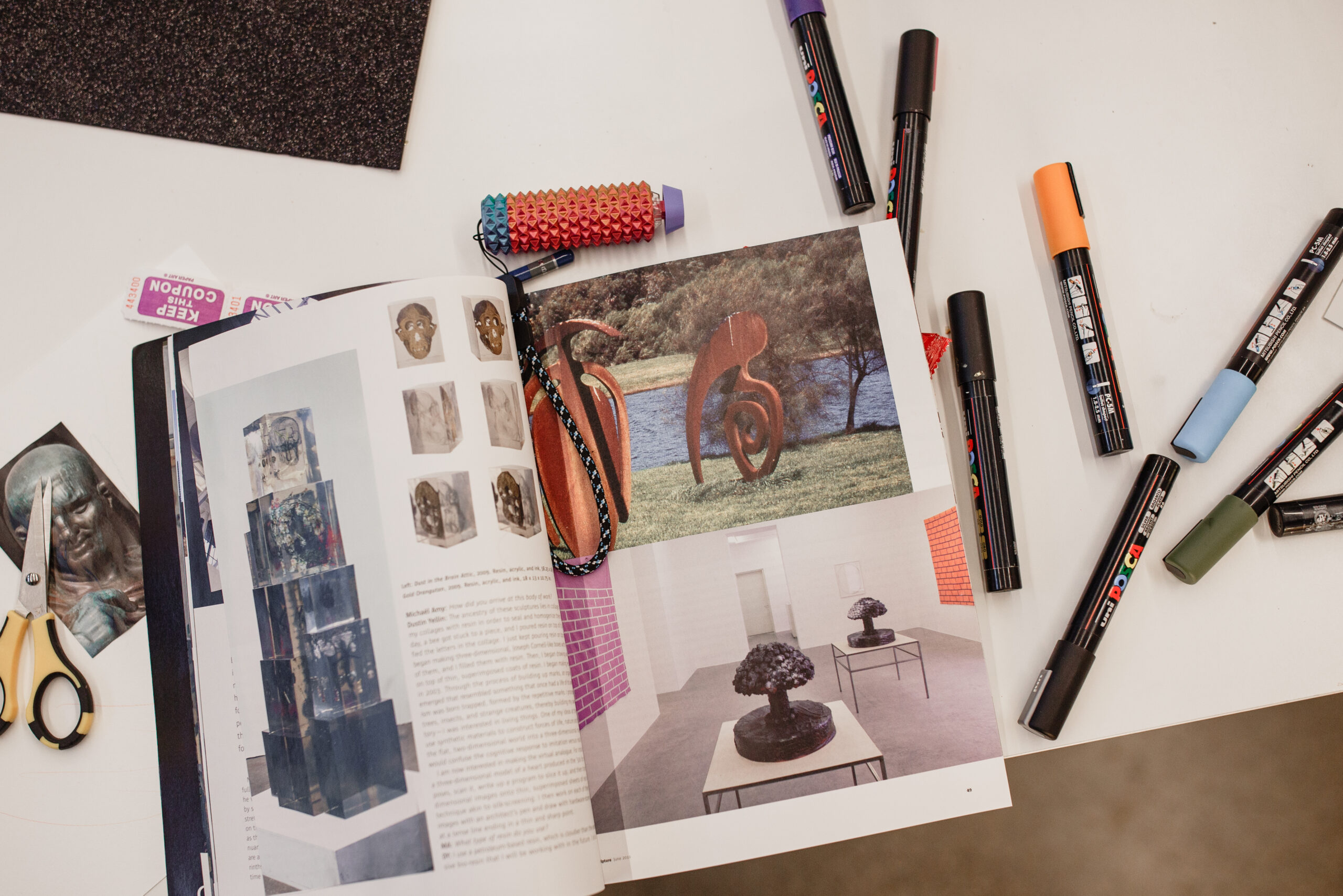 Art materials cover a table in the studio at the artHOME.