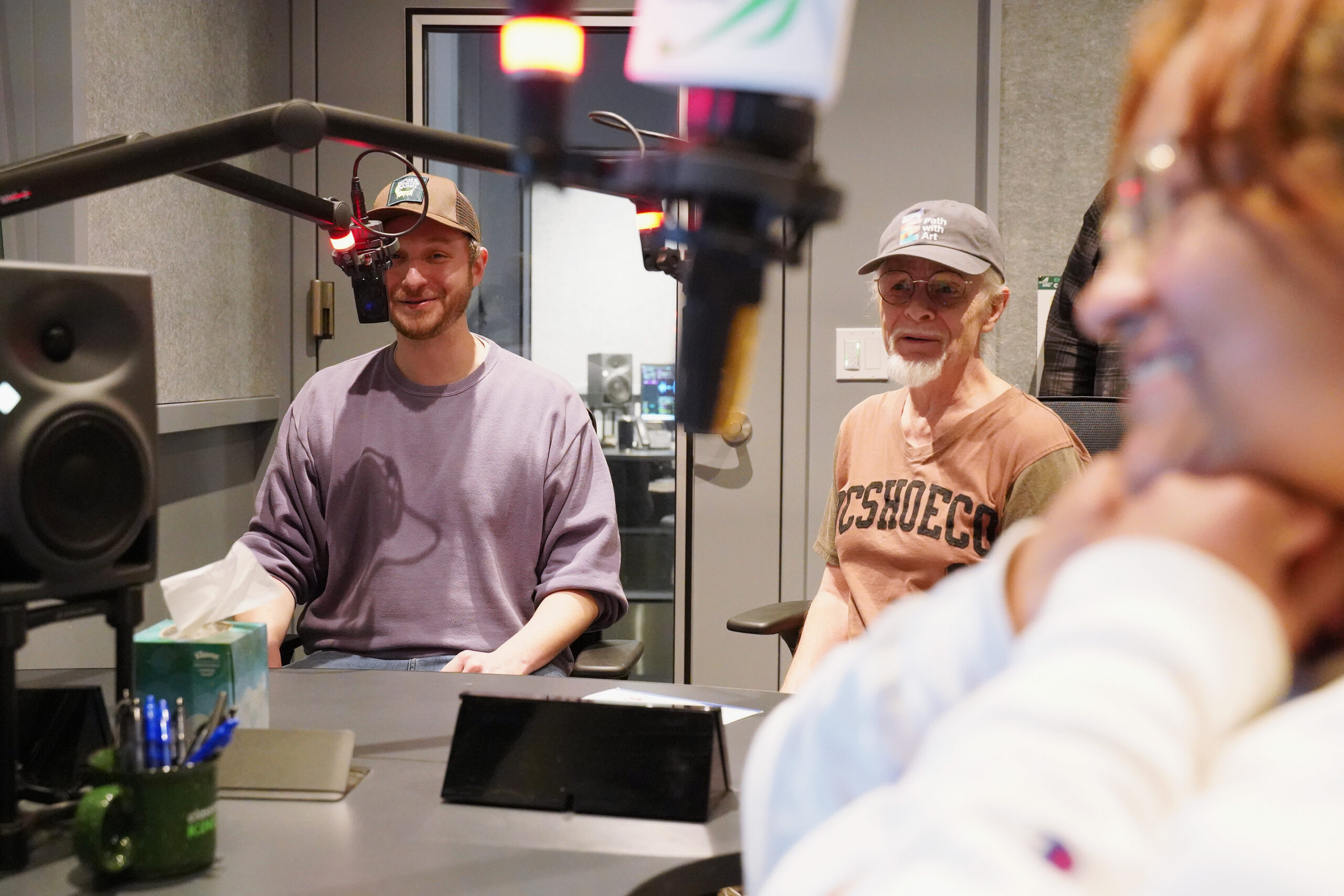 A Participant Artist and Teaching Artists record in the studio at Classical King FM during Podcasting Class.