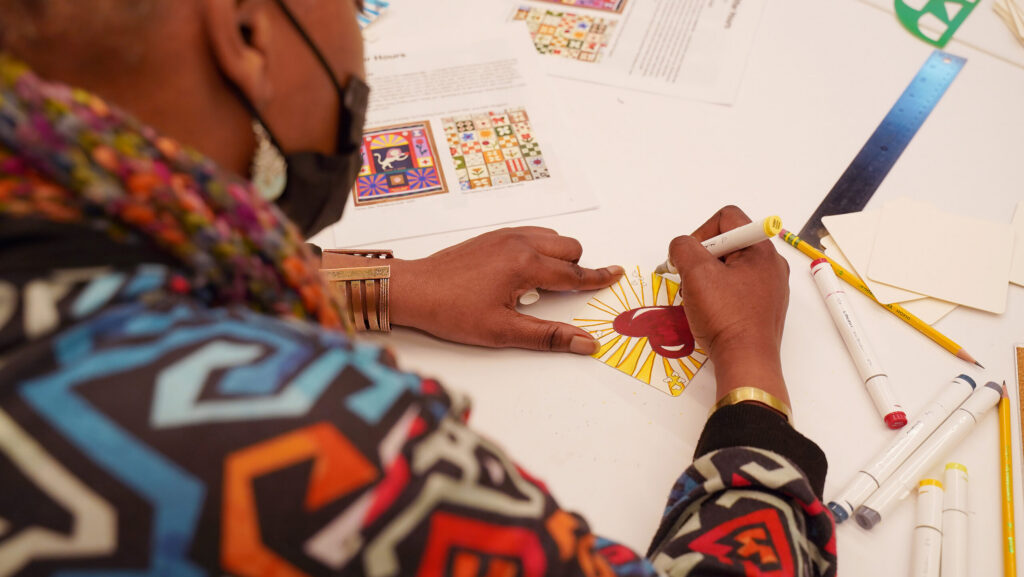 An attendee at Art After Hours colors in a heart.