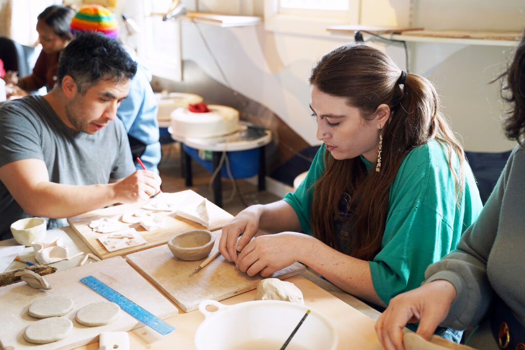Participant artists hand-build clay forms at Yu Tang Studios.